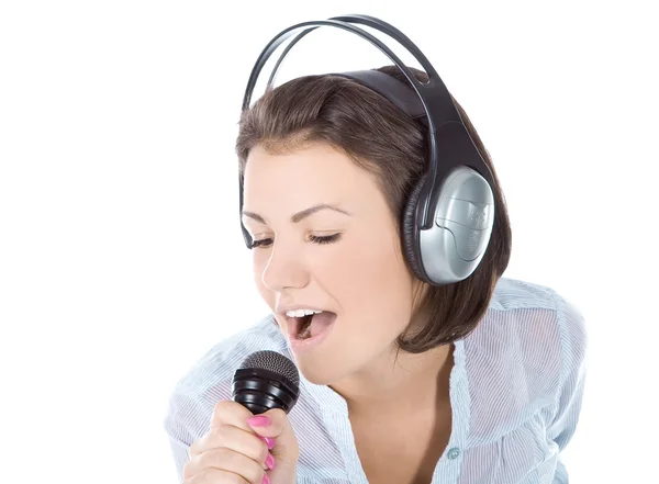 Caucasian female singing into microphone. — Stock Photo, Image