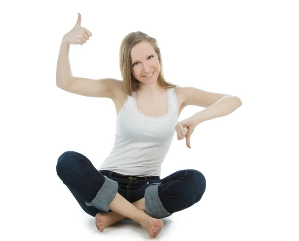 Lovely woman in jeans shouing thumbs up and thumbs down — Stock Photo, Image