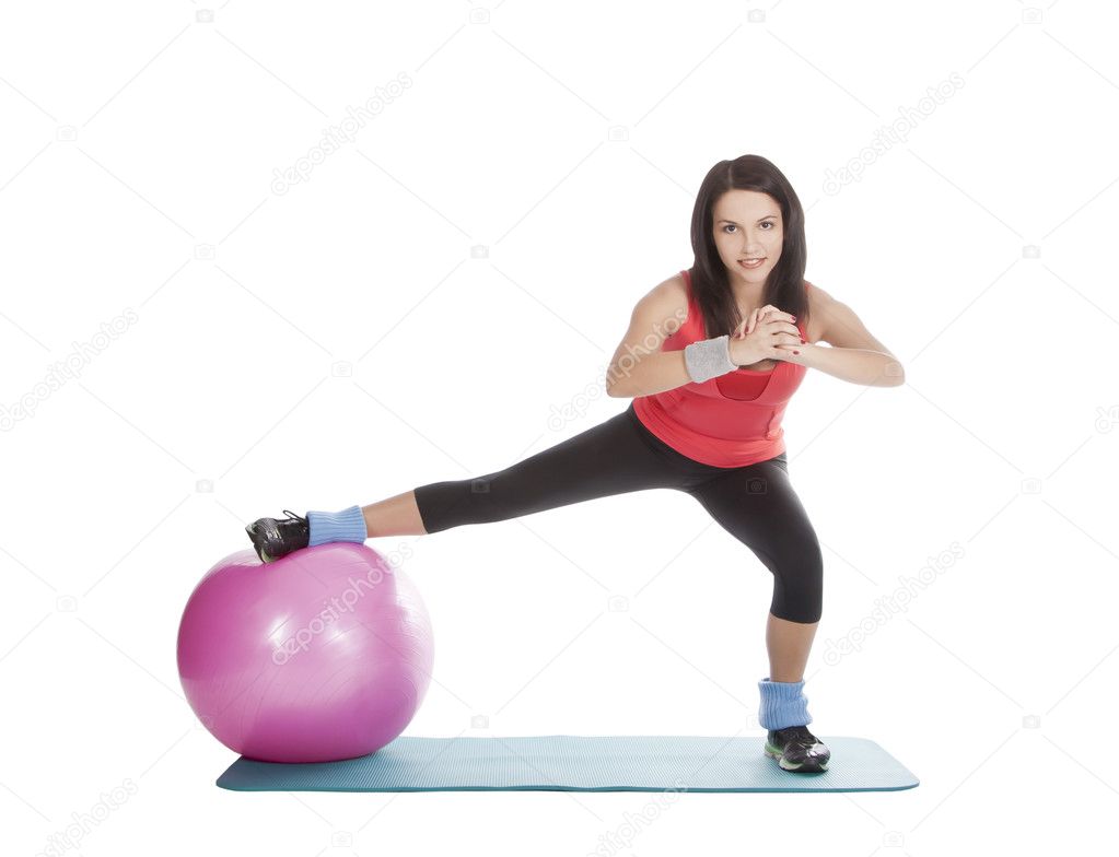 Attractive young female with fitness ball in stretching