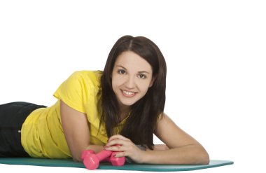 Attractive young female with fitness dumbbells in sport center clipart