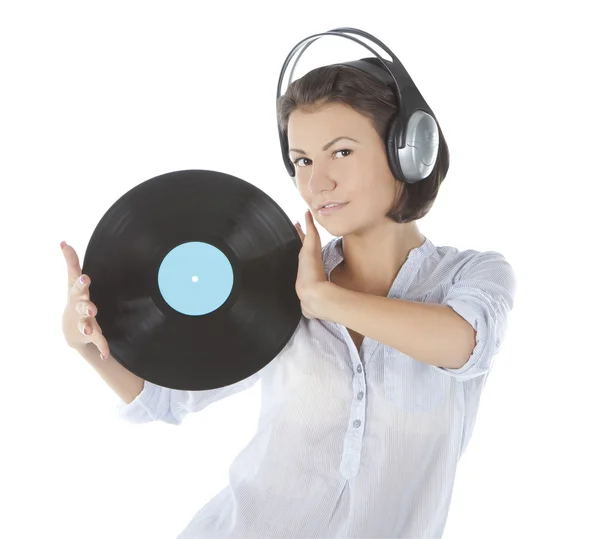 Emotional brunette in headphones with vinyl record over white — Stock Photo, Image