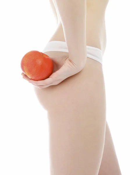 Štíhlá žena drží jablko — Stock fotografie