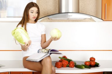 Beautiful young woman ready to prerare salad clipart