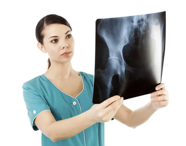 Thoughtful female doctor looking at the x-ray image — Stock Photo, Image