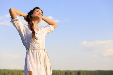 Young happy woman in green field clipart