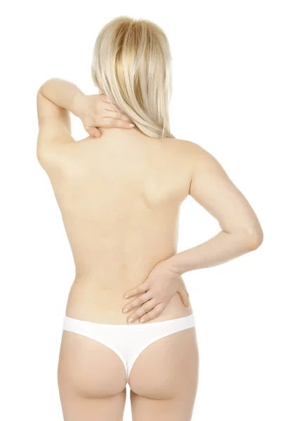 Mujer masajeando el dolor de espalda aislado sobre un fondo blanco . —  Fotos de Stock