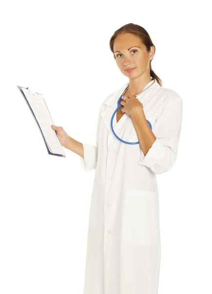 Smiling female doctor holding a clipboard against white backgrou — Stock Photo, Image