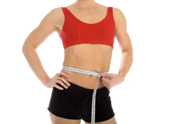 Mulher desportiva com uma fita métrica em volta da cintura — Fotografia de Stock