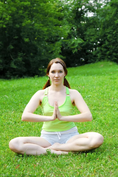 Young beautiful woman in yoga position, outdoors. — Stock Photo, Image