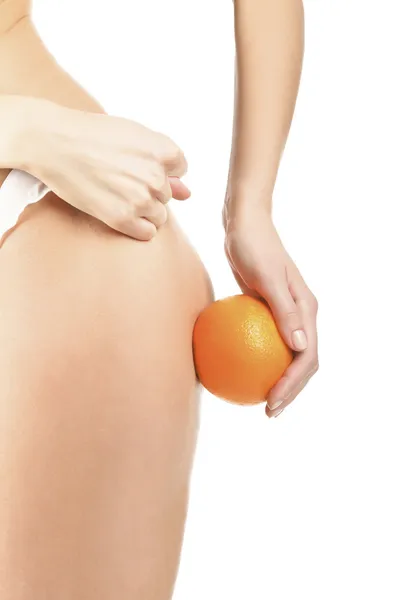 Slim woman shows the fig to cellulite, isolated on white backgro — Stock Photo, Image