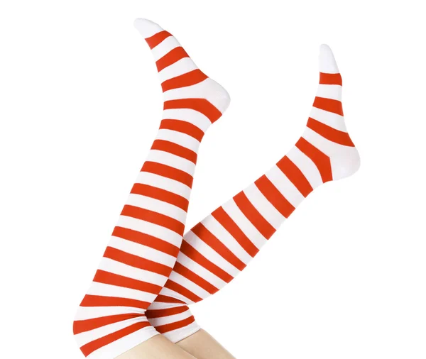 Kerstmis vrouwelijke benen, geïsoleerd op witte achtergrond — Stockfoto