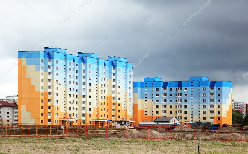 Construction of houses on the background of a stormy sky