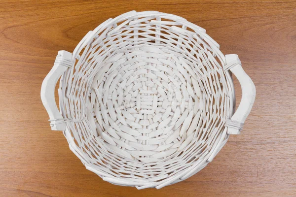 Wicker basket on table, top view — Stock Photo, Image