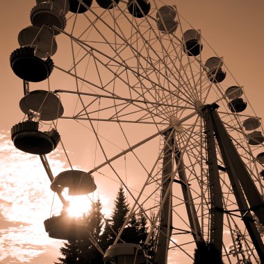 Ferris wheel at sunset clipart