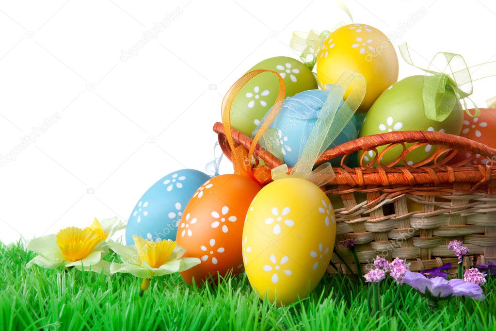 Color easter eggs with green grass on the white
