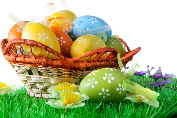 Color easter eggs in basket isolated on white — Stock Photo, Image