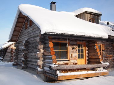 Traditional snow covered log cabin clipart