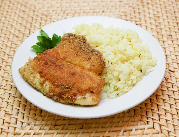 Fried breaded tilapia served with rice and herbs — Stock Photo, Image
