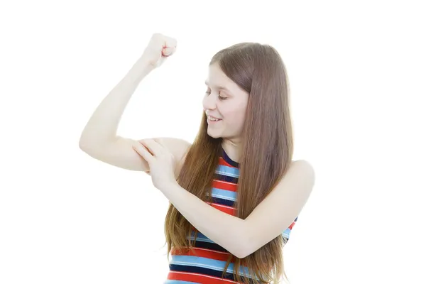 Smiling teenage girl measures her biceps — Stock Photo, Image