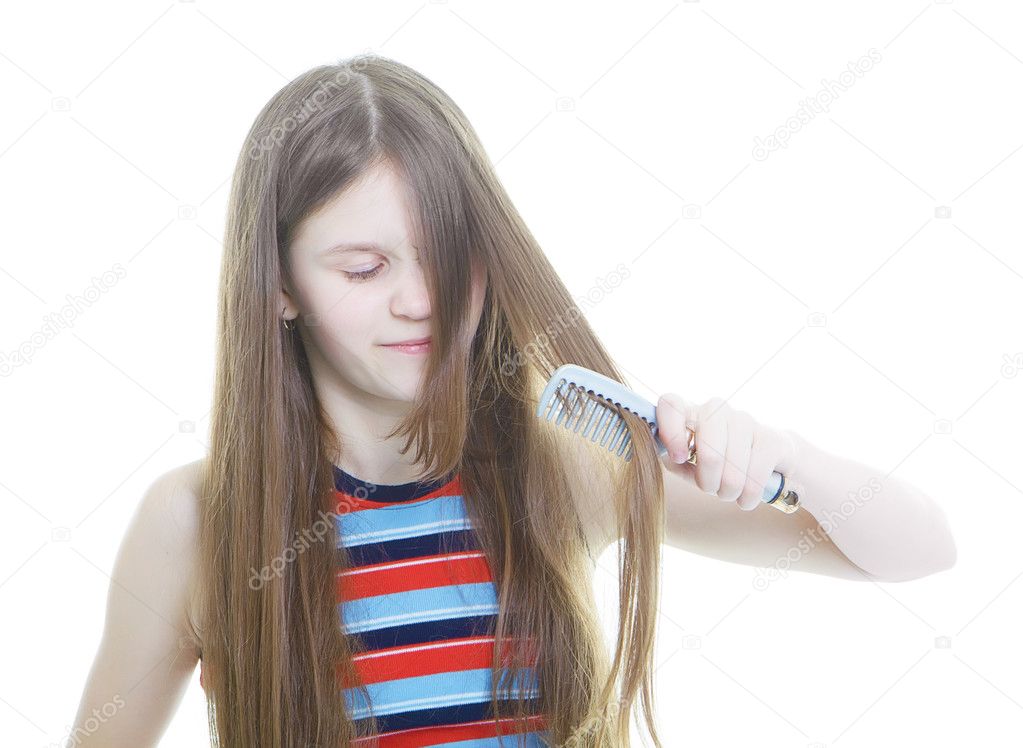 Teen girl combing her long hair
