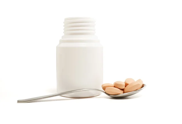 Pills bottle and spoon — Stock Photo, Image