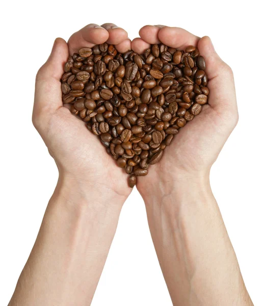 Форма серця, зроблена з кавових зерен в руках — стокове фото