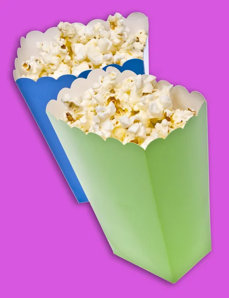 Яскраві кольорові коробки для лікування заповнені попкорном — стокове фото