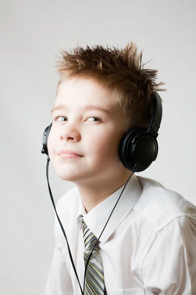 stock image Young boy listening to head phones