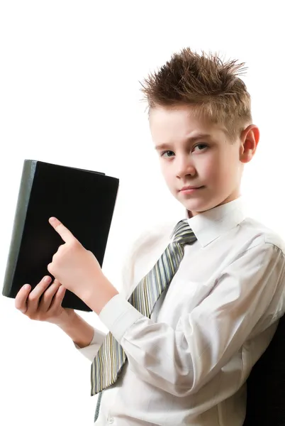 Serious boy points his finger at the book — Stock Photo, Image