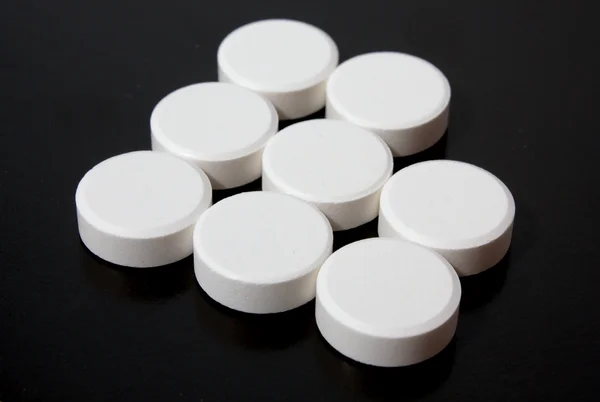 Abstraktes Logo weißer Tabletten — Stockfoto