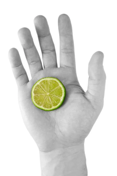 緑のレモンと手します。. — ストック写真
