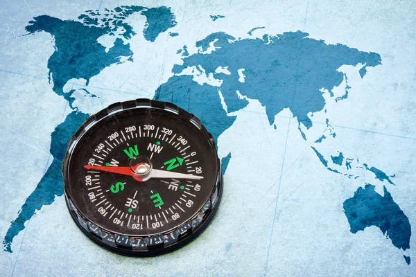 Kompass auf der blauen Weltkarte. — Stockfoto