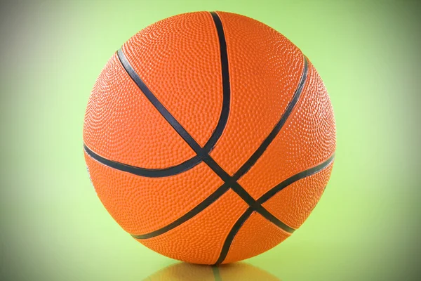 Basketball ball over a green background. — Stock Photo, Image