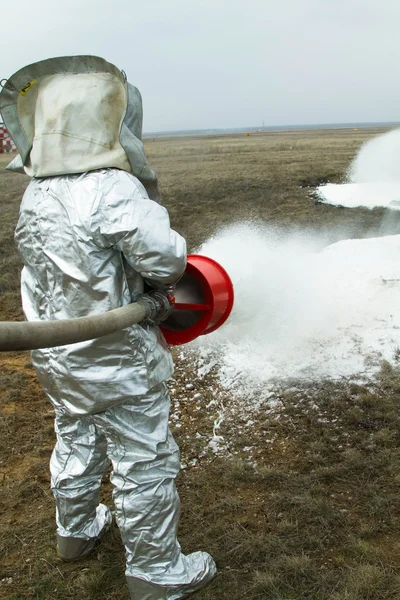 stock image Fire in a silver protective suit.