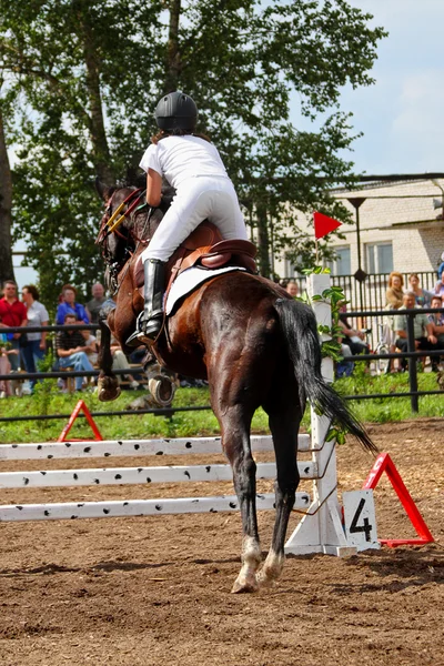 Competitions on concours - the woman jumps through a barrier — Stock Photo, Image