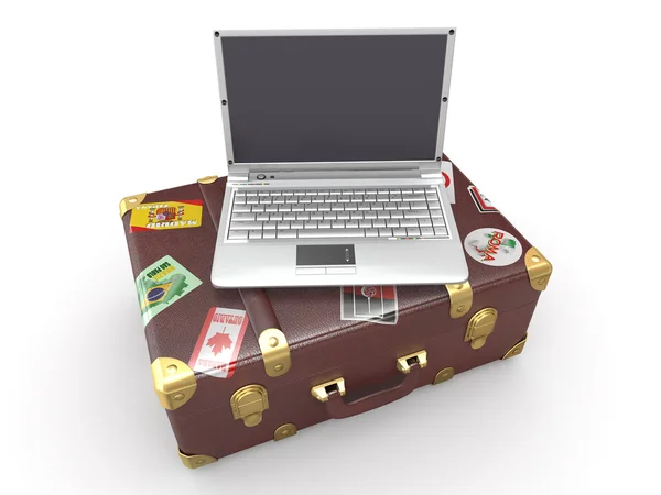 Ноутбук и чемодан — стоковое фото