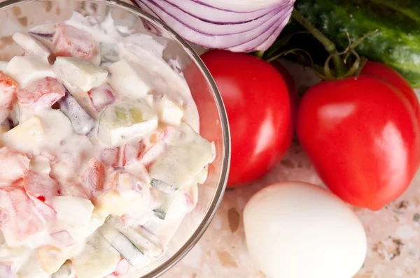 stock image Fresh vegetable salad dressed with sour cream.