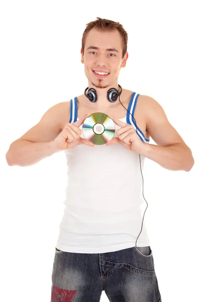 Молодий чоловік у навушниках тримає музичний диск — стокове фото
