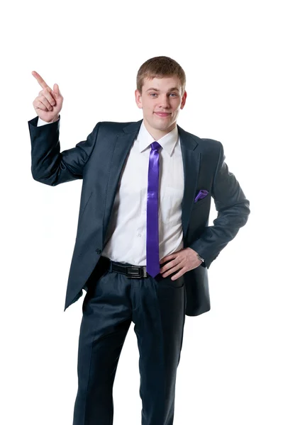 Młody biznesmen w garniturze pokazuje ręką do góry — Zdjęcie stockowe