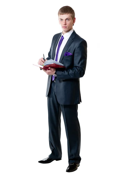 Mladý podnikatel v obleku s deník — Stock fotografie