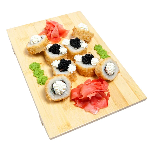 Hengerelt sushi, fa állványon — Stock Fotó
