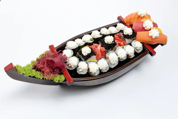 Set of sushi on wooden stand in the form of the boat — Stock Photo, Image