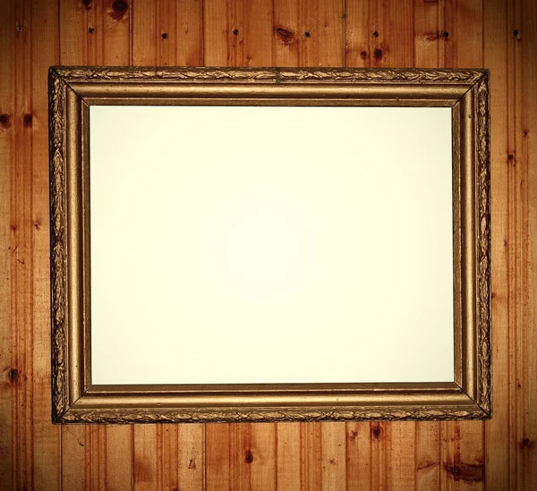 Empty frame over wood wall — Stock Photo, Image
