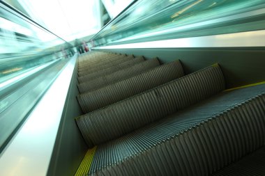 Moving escalator inside contemporary airport clipart