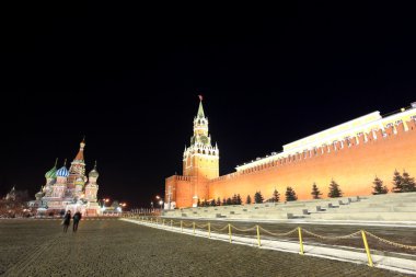 Spassky Tower and St Basil's Cathedral in Red Square at night in clipart