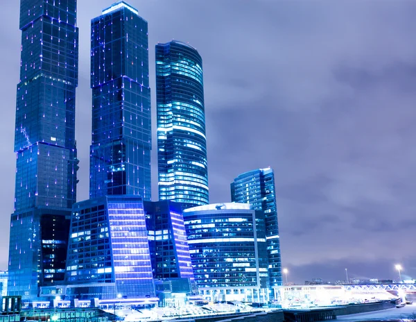 Prospective view to glass high-rise building skyscrapers at nigh — Stock Photo, Image