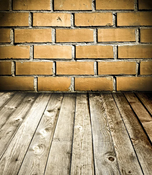 Red brick wall and wooden floor, rural interior — Stock Photo, Image