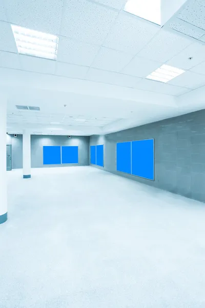 Light hall with blank blue placards — Stock Photo, Image