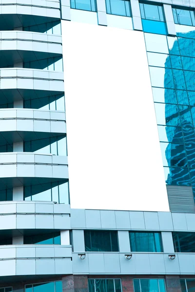 Blue glass wall with blank placard of skyscraper — Stock Photo, Image