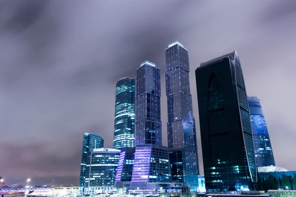 Stock image Prospective view to glass high-rise building skyscrapers at nigh